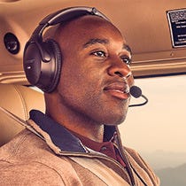 Pilot flying plane wearing aviation headset