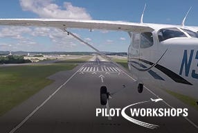 Airplane flying near runway on sunny day